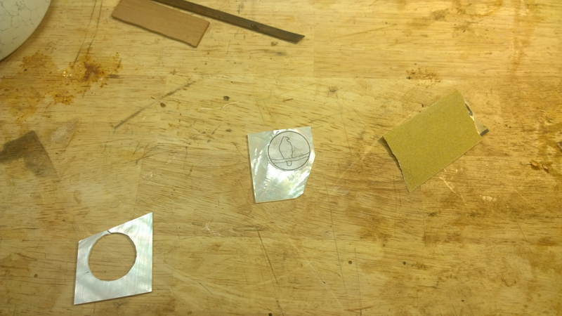 Hawk and moon logo inlay